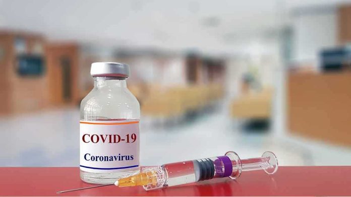 shutterstock_1643122693 vaccine vial and syringe on a counter in a clinic