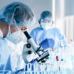 Metabolites Detected — What’s In The Glass? Scientist using a microscope in a laboratory