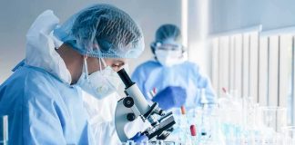 Metabolites Detected — What’s In The Glass? Scientist using a microscope in a laboratory