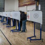 Hacking Risks Exposed—Did Votes Change? Voters at polling booths in a gymnasium