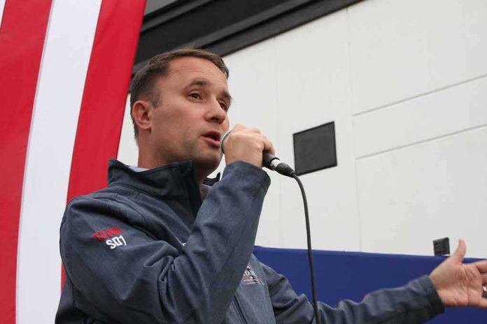 Man speaking into a microphone at an outdoor event