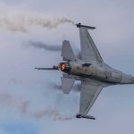 Deterrence Doubts Mount As Missiles Fly Fighter jet banking with afterburner against a cloudy sky
