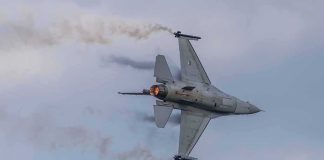 Deterrence Doubts Mount As Missiles Fly Fighter jet banking with afterburner against a cloudy sky