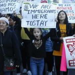 Viral Rage Runs On 2020 Footage Protesters march holding signs and banners
