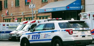 Fleeing Driver, Injured Congresswoman Police car and ambulances outside emergency room entrance.