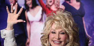 Beloved Icon Gone — Nashville Holds Its Breath blonde woman waving at a red carpet event