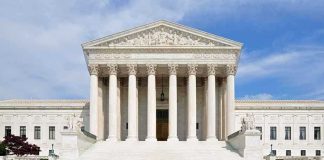 Birthright Brawl Explodes After Supreme Move Front view of the Supreme Court building with large columns and steps under a blue sky