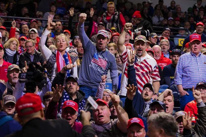 shutterstock_1646598625 Crowd of supporters cheering at an indoor political rally