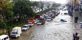 Killer Floods Slam Indiana Flooded city street with stranded vehicles and traffic jam
