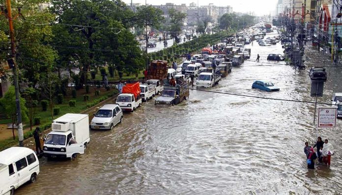 shutterstock_1784804417 Flooded city street with stranded vehicles and traffic jam