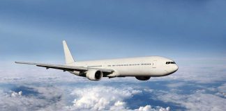 Google Reroutes Jets—Climate Gamble Begins A white airplane flying above fluffy clouds in a blue sky