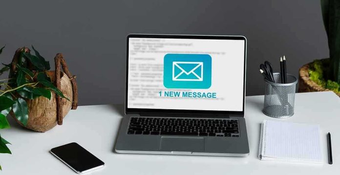 shutterstock_1912319569 laptop on desk showing new email notification