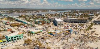 Tropical Trap: Downgrade Danger GROWS Aerial view of coastal town with widespread storm damage