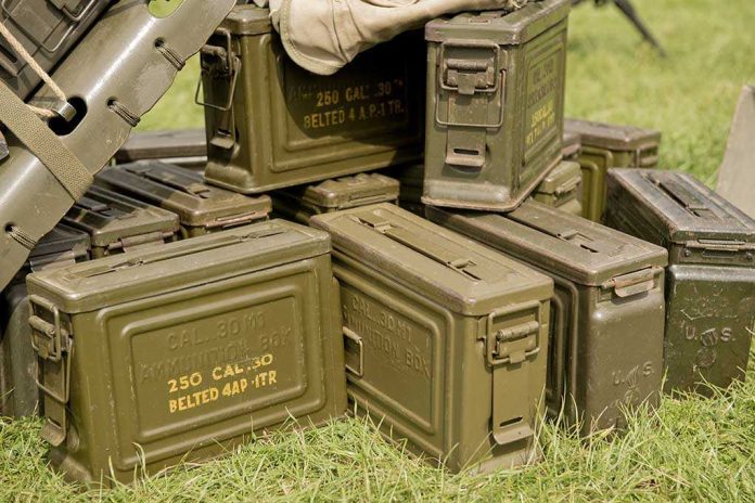 shutterstock_233391562-1 Stack of green military ammunition boxes on grass