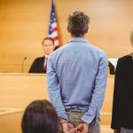 Officer Caught Lying—Verdict Vanishes Defendant in handcuffs stands before a judge in a courtroom