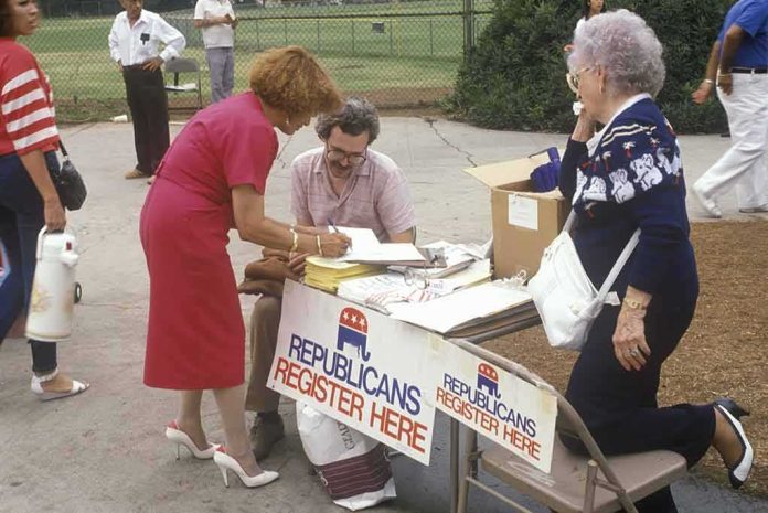 shutterstock_265784873 People at an outdoor voter registration table