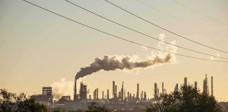 Evidence Mounts: Russia’s Refineries Reeling Industrial refinery with smokestack emitting plume at sunset