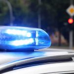 A Trading Card Collection Drew Armed Intruders Police car blue siren light flashing