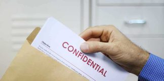 China-to-U.S. Pipeline Exposed – GLP-1 Chaos Hand placing confidential document into a brown envelope