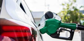 Gas Gamble Explodes Across Southeast Asia Green fuel nozzle pumping gas into a white car