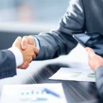 Stafford’s $60M Deal EXPOSED as Illusion? Businesspeople handshake at meeting table