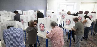Fraud Verdict Shakes Quiet California Town Voters fill out ballots at polling booths in a busy voting room