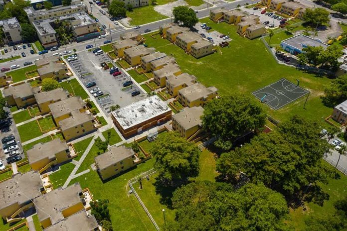 shutterstock_1407836984 Aerial view of apartment complex with parking lots and a basketball court