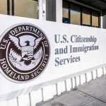 65,000 Trafficking Reports Ignored. Trump Is Now Knocking on Doors. USCIS sign at a federal building entrance
