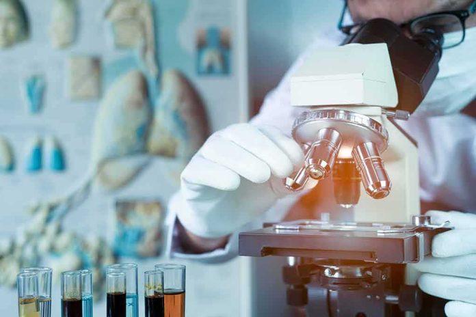 shutterstock_1709567449 Scientist using a microscope in a lab