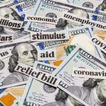 Hundred-dollar bills with cutout words about stimulus and economy