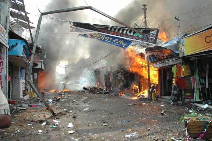 Street marketplace engulfed in fire and heavy smoke