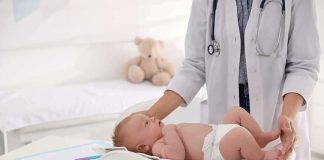 Judge Says Mom Insane—Now What? Pediatrician weighing a baby on an infant scale