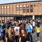 Frat Night Allegations Meet DA’s Receipts Students gathered outside a school building entrance