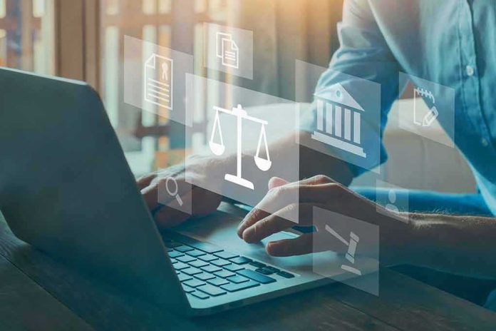 shutterstock_1856273797 Person typing on laptop with legal icons overlay
