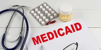 Medicaid Heist Exposed — Judge Lowers Boom Medicaid document with stethoscope and medications on desk