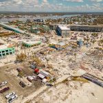 Coastal Punch Incoming: Tides Won’t Drain Aerial view of coastal town with widespread storm damage