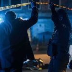 Austin Outrage Builds – Feds Control The Scene Investigators at night lifting police tape at a crime scene