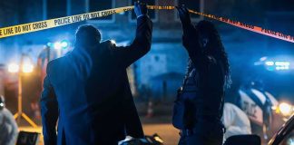 Austin Outrage Builds – Feds Control The Scene Investigators at night lifting police tape at a crime scene