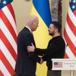 Putin Meeting Ends With Careful Words Two men shake hands at a podium with U.S. and Ukrainian flags