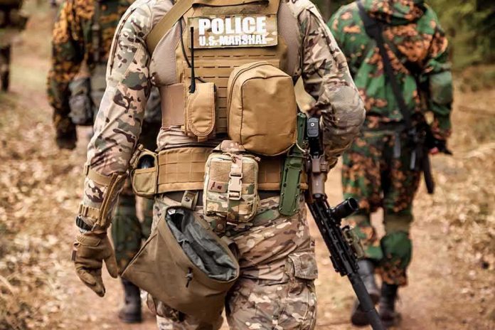 shutterstock_2336735477 Tactical officers in camouflage gear walking on a forest trail