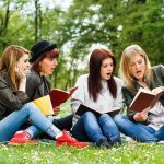 Gen Z Marriage Surge – Match Makes Bold Play Group of young women reading books on grass in a park