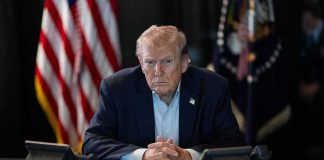 Anti Trump Brewery Now Faces Possible Closure Donald Trump seated at a table between two desk phones