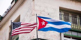 American and Cuban flags on a wrought-iron balcony