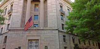 America’s Secret Terror Court Just Acted Stone government building with American flag at entrance