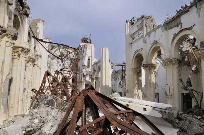 shutterstock_60670489 Interior view of a destroyed building with collapsed arches and debris
