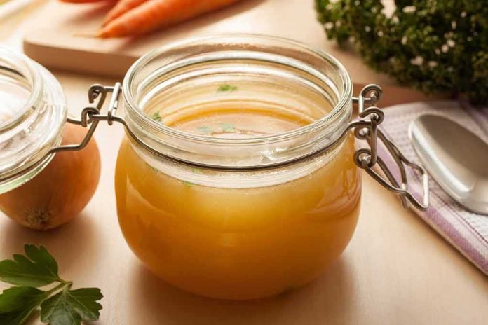 shutterstock_616312391 Glass jar of homemade broth on a kitchen counter