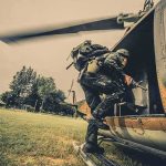 Helicopters Hunt Pot Over Backyards Soldier boarding a helicopter during field operation