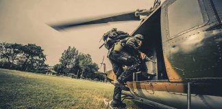 Soldier boarding a helicopter during field operation