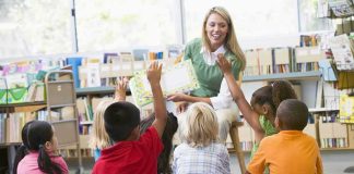 Child Abuse Firestorm – Paris Schools Under Siege Teacher reading to children in a library circle