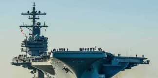 Pentagon Glory, Congress Smells Smoke Aircraft carrier guided by tugboats in a harbor